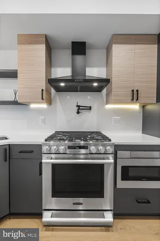 a stove top oven sitting inside of a kitchen
