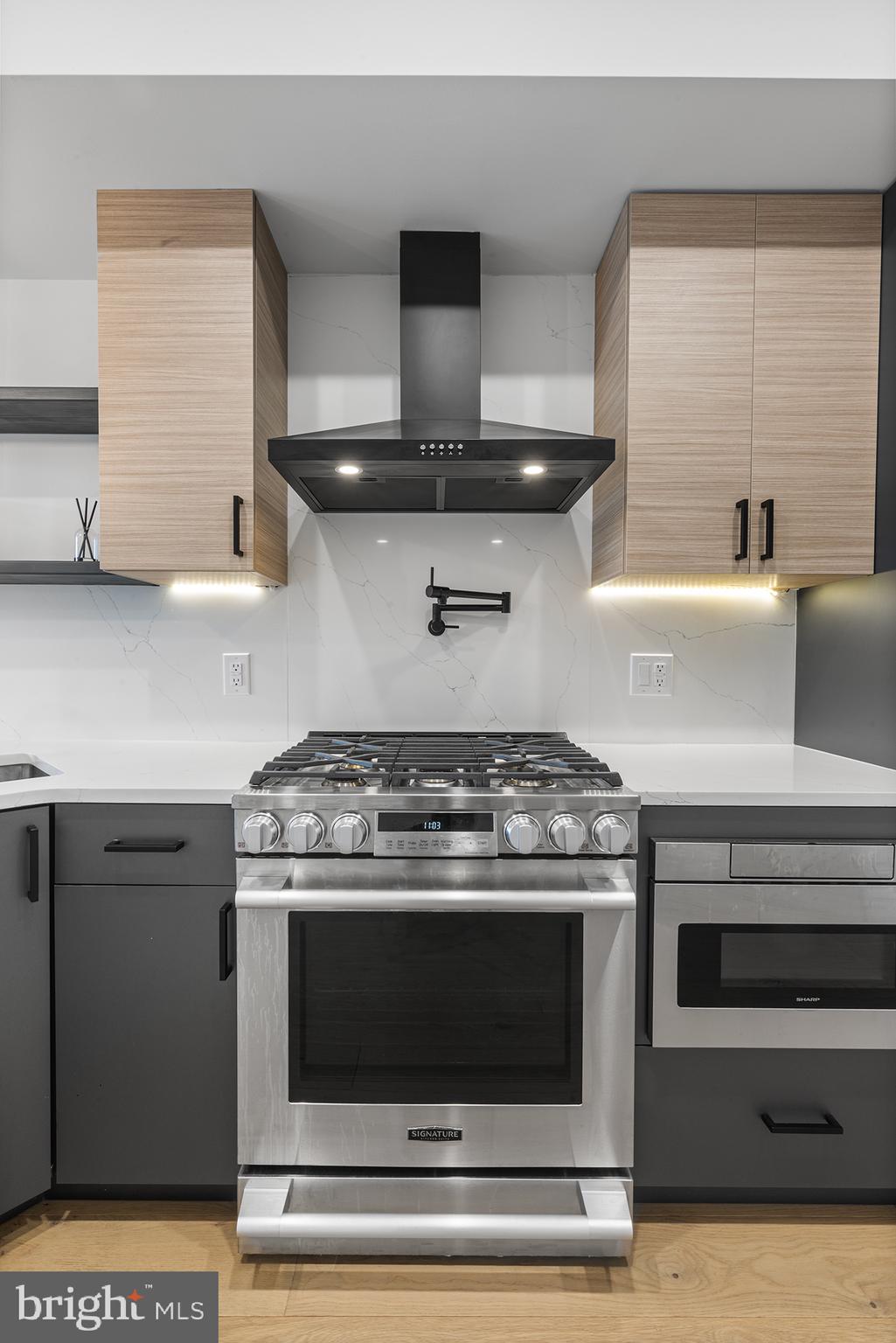 1507 Christian Street, Unit 4 Philadelphia, PA 19146 - Photo 4 of 26 a stove top oven sitting inside of a kitchen