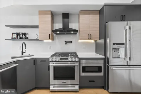 a kitchen with stainless steel appliances a stove and a refrigerator