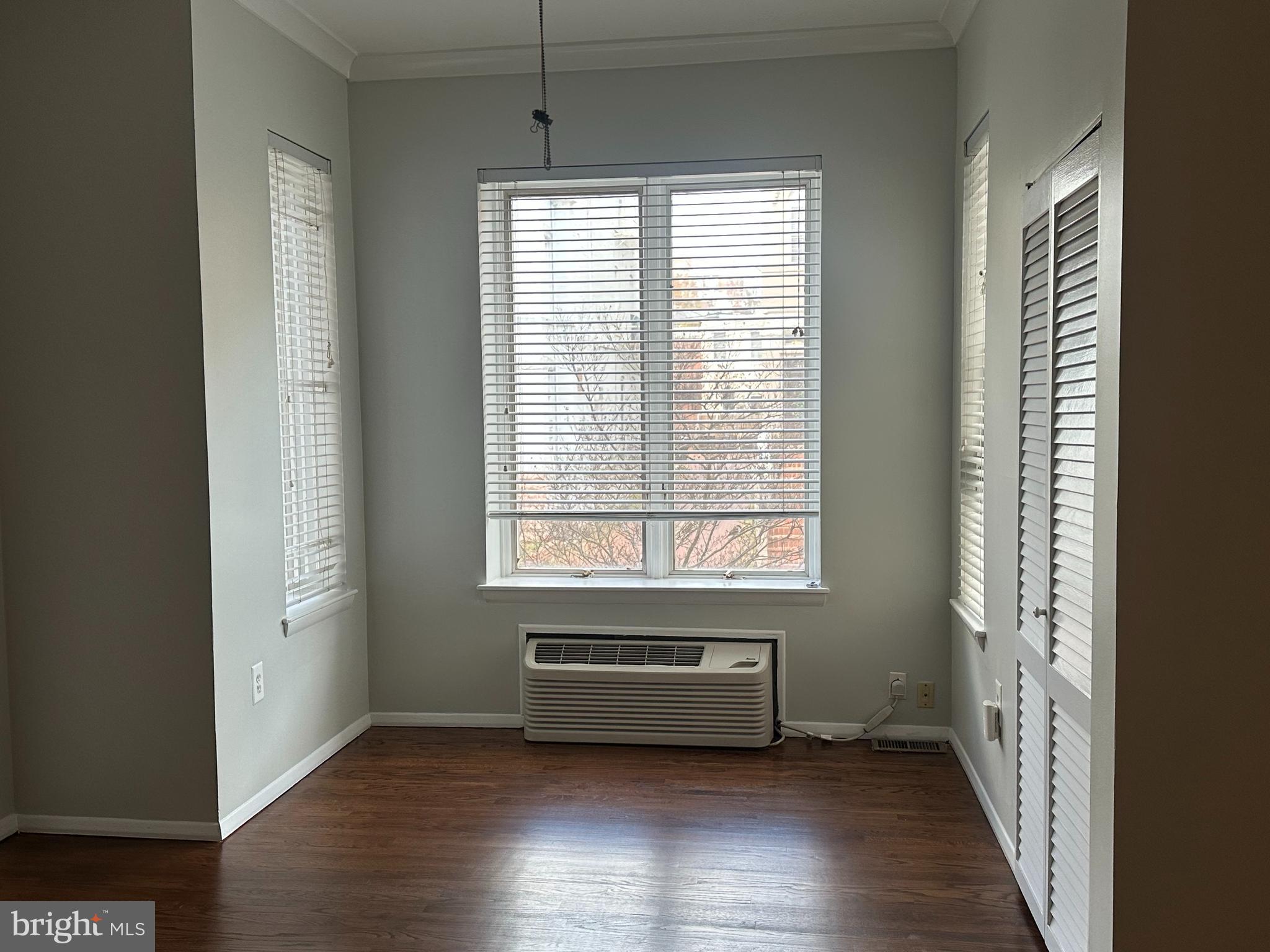 2120 N Street Northwest, Unit 101 Washington, DC 20037 - Photo 12 of 21 a view of a room with wooden floor and windows