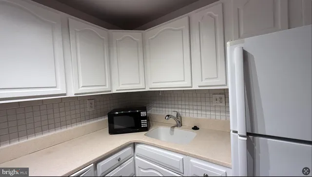 a kitchen with a sink and cabinets