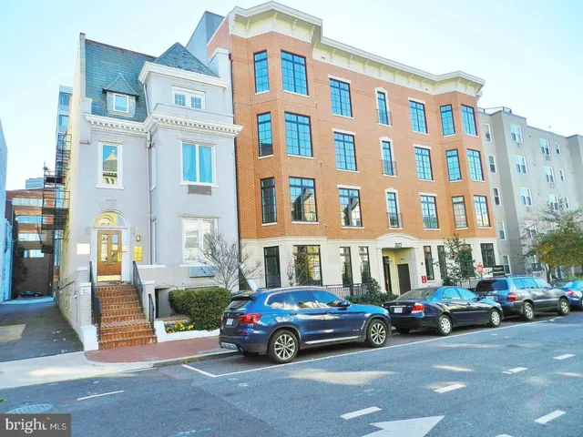 a view of building with car parked