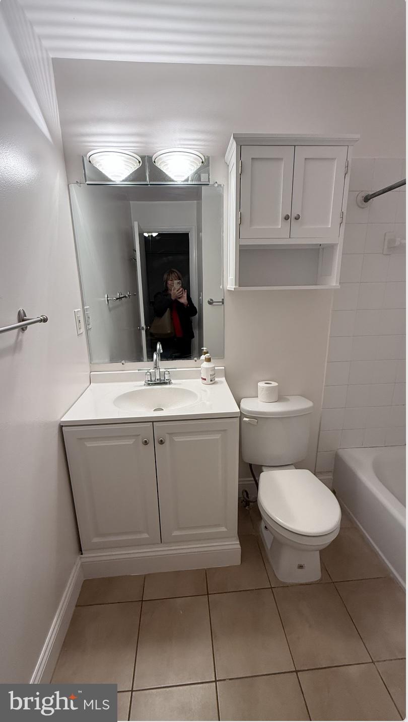 2120 N Street Northwest, Unit 101 Washington, DC 20037 - Photo 21 of 21 a bathroom with a toilet sink and mirror