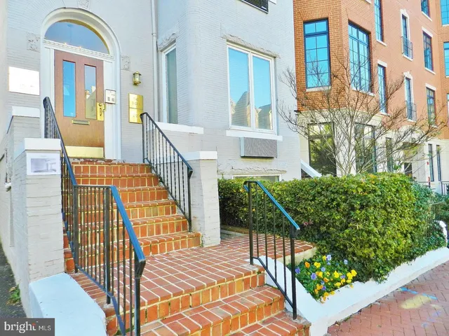 a view of staircase with railing and a potted plant