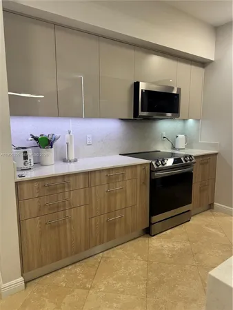 a kitchen with sink cabinets and stainless steel appliances