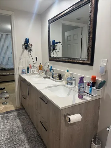 a bathroom with a double vanity sink and a mirror