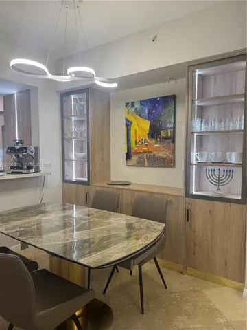 a dining room with furniture and window