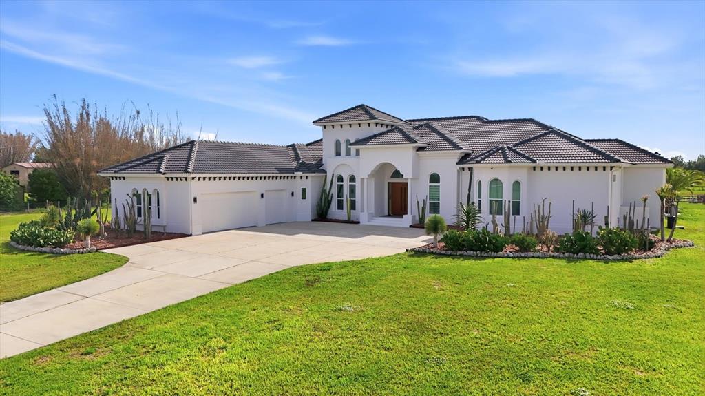 14325 MJ Road Myakka City, FL 34251 - Photo 69 of 79 a front view of a house with a yard and garage