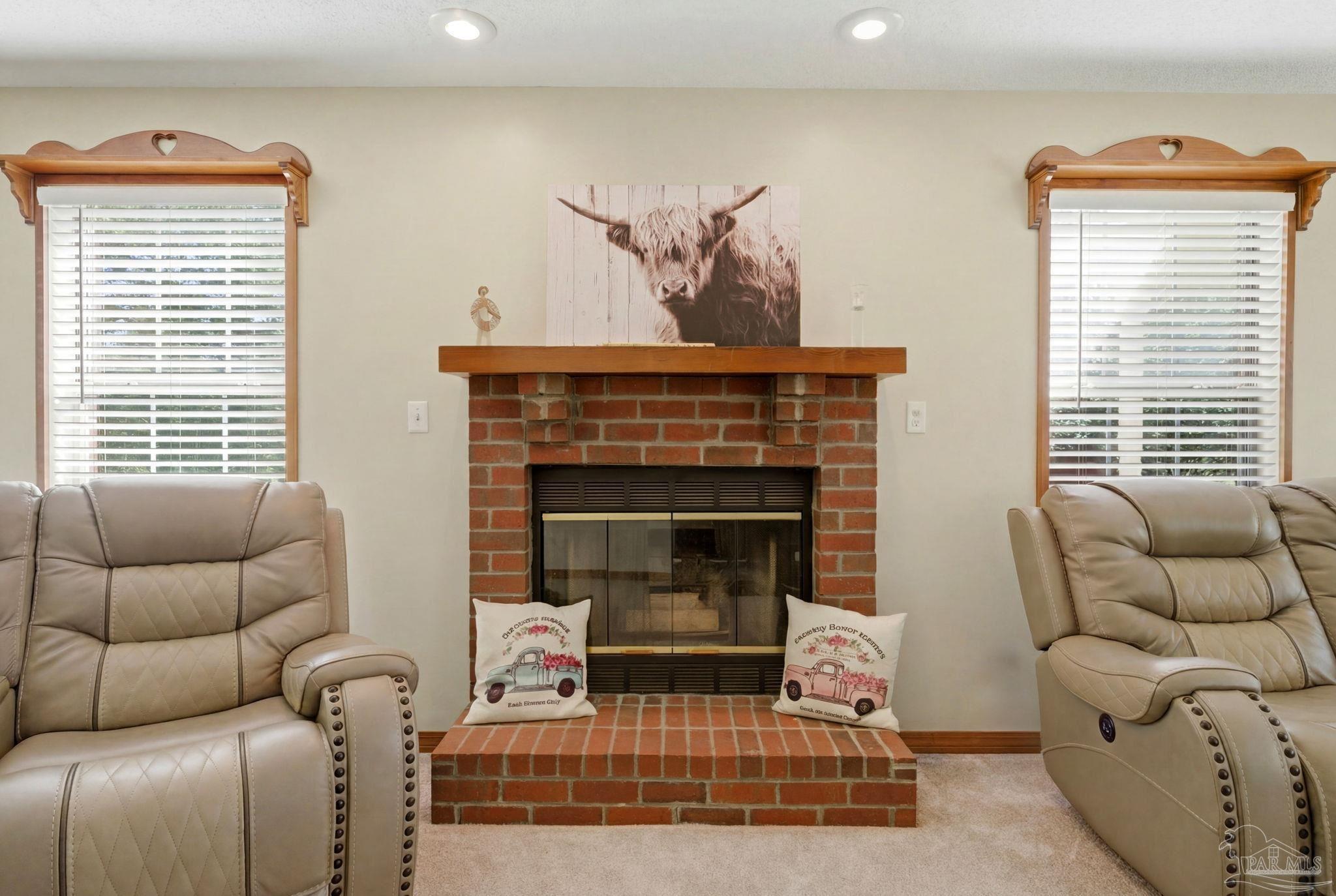 6870 Martin Road Milton, FL 32570 - Photo 19 of 48 a living room with furniture a window and a fireplace