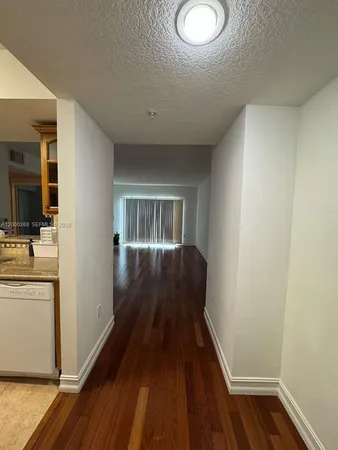 a view of a hallway and wooden floor