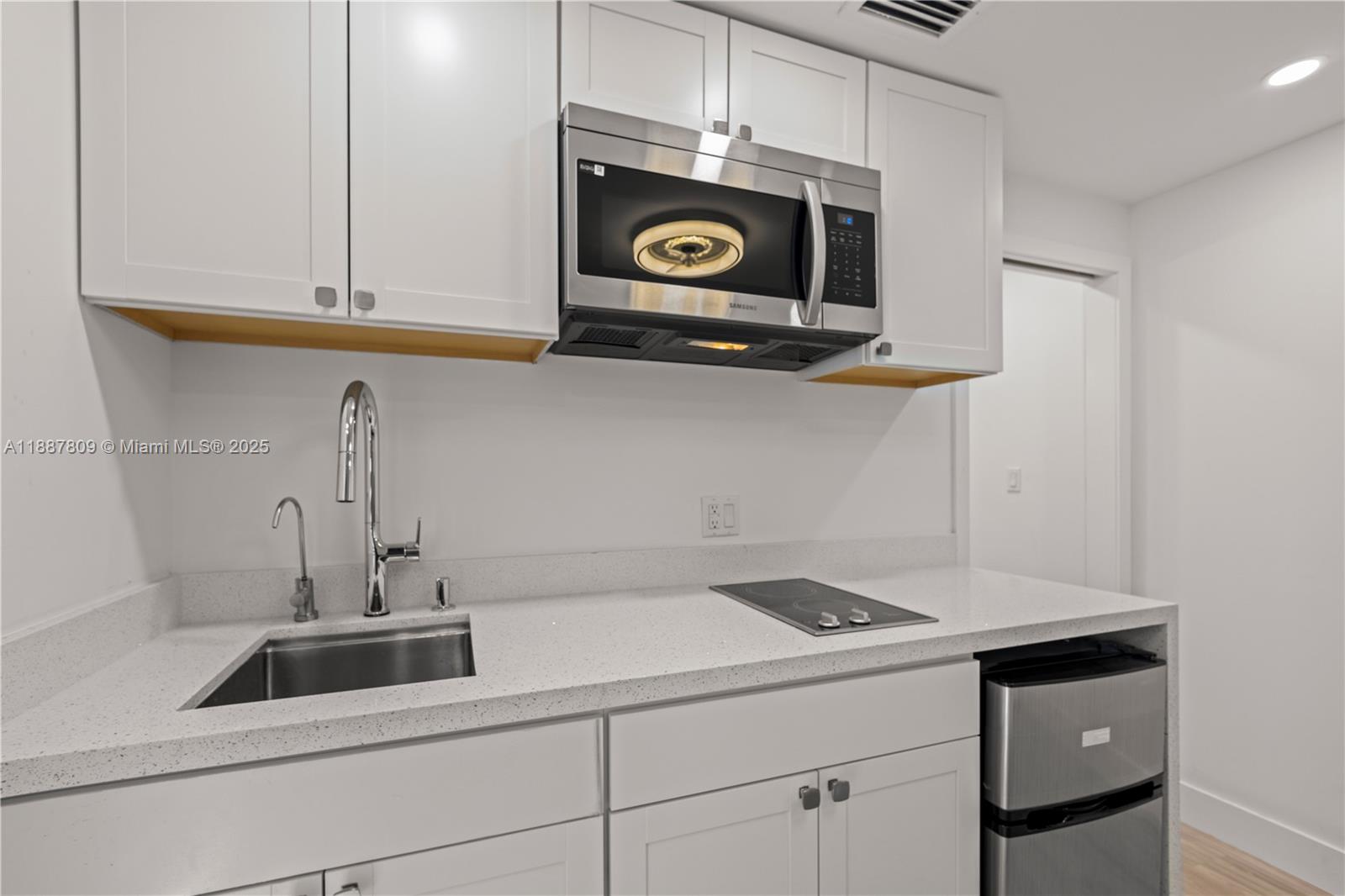 5855 Southwest 62nd Street, Unit 5 Miami, FL 33143 - Photo 2 of 13 a kitchen with a sink and cabinets