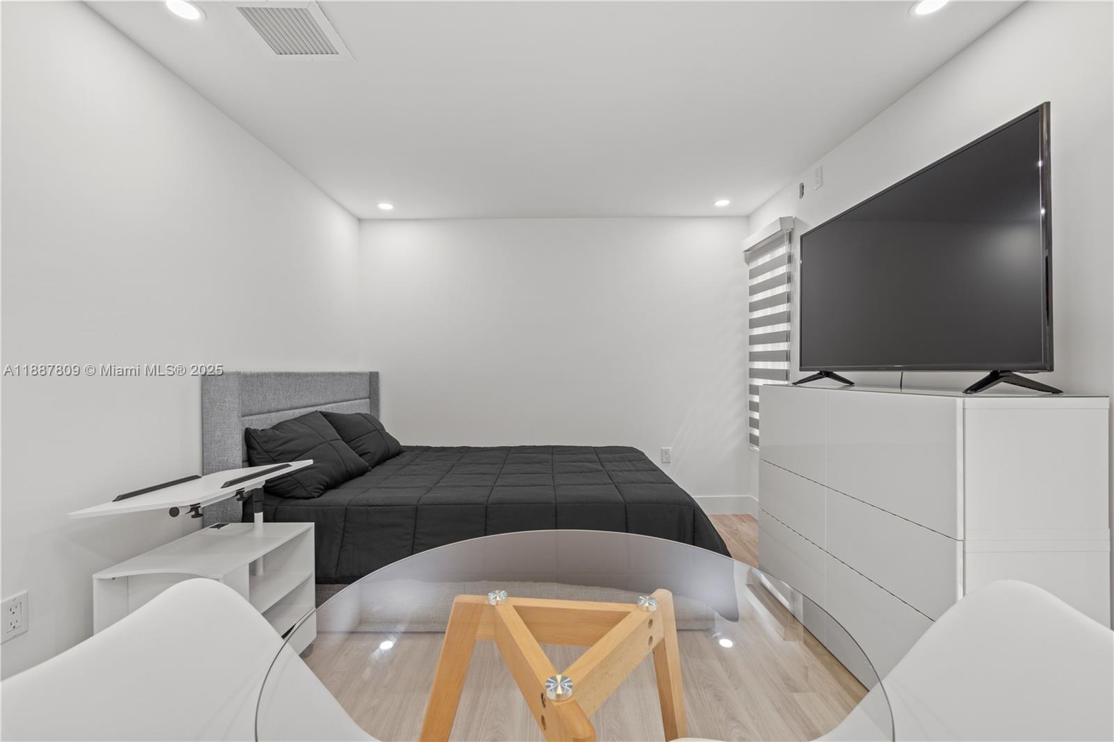 5855 Southwest 62nd Street, Unit 5 Miami, FL 33143 - Photo 6 of 13 a bedroom with a bed and flat screen tv