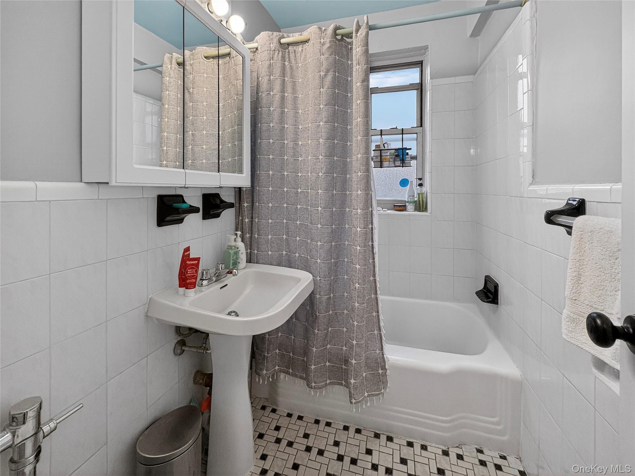 65-70 Booth Street, Unit 6F Queens, NY 11374 - Photo 7 of 11 a bathroom with a sink a toilet and shower