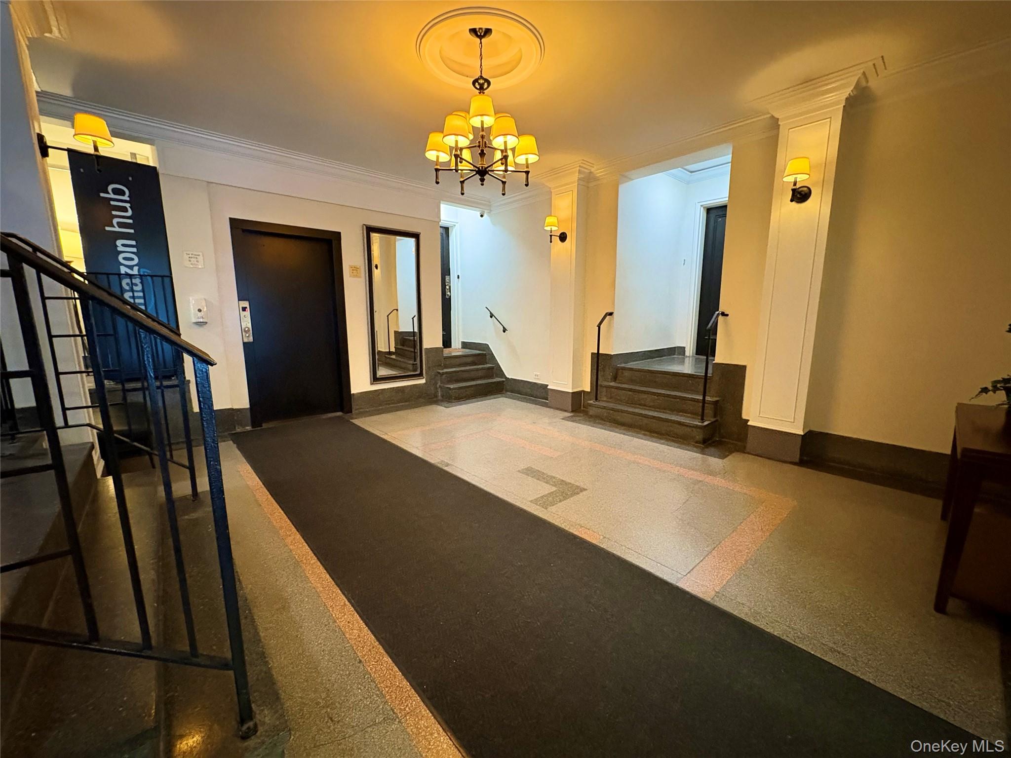 65-70 Booth Street, Unit 6F Queens, NY 11374 - Photo 9 of 11 a spacious bedroom with a bed and a chandelier