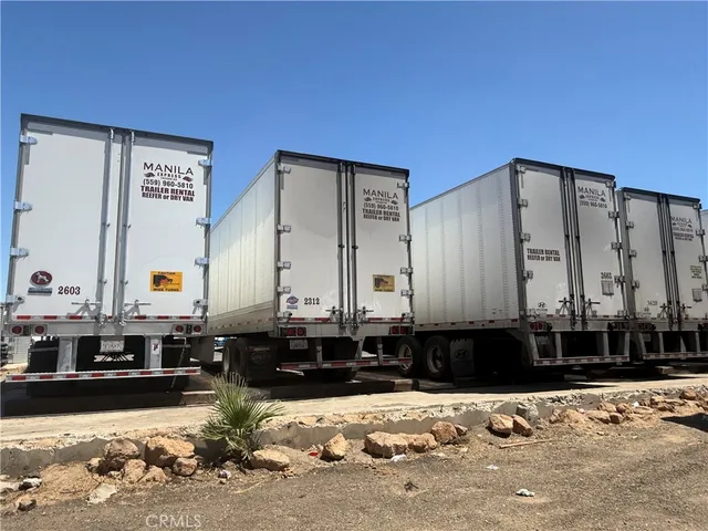 a front view of a house with a yard and car parked
