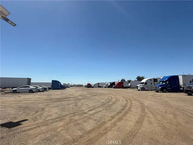 a view of a large mirror and hard wood floor