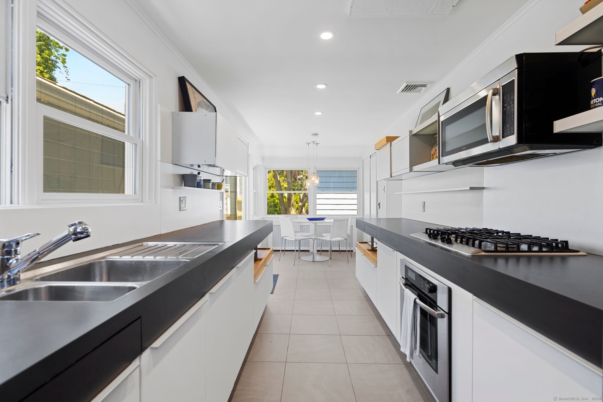 232 Hillspoint Road Westport, CT 06880 - Photo 12 of 39 a kitchen with stainless steel appliances granite countertop a sink stove and microwave