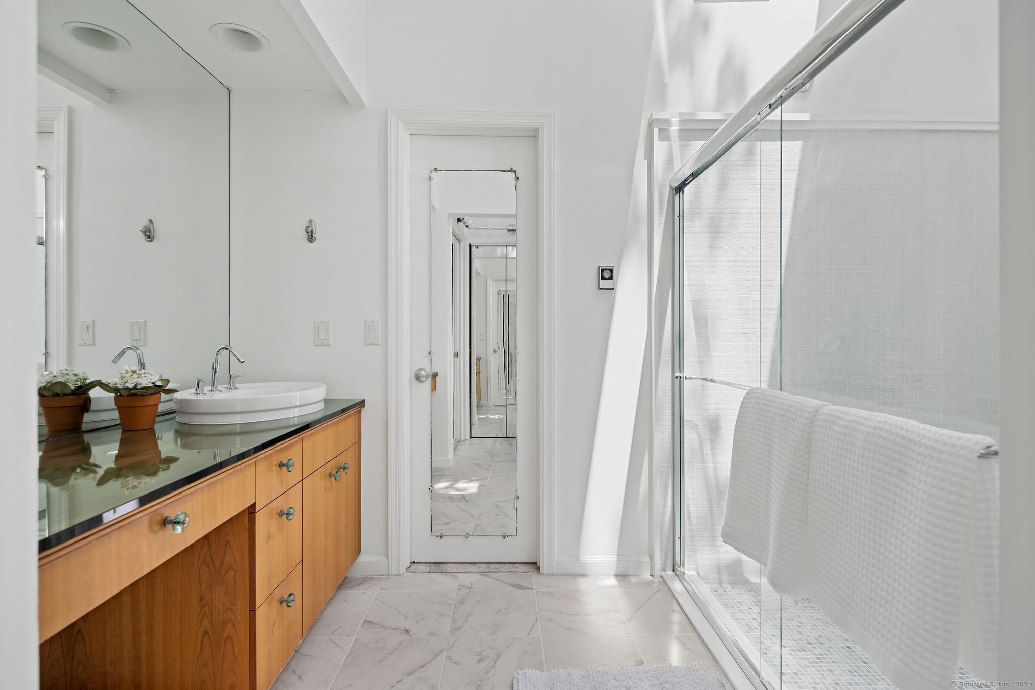 232 Hillspoint Road Westport, CT 06880 - Photo 13 of 39 a spacious bathroom with a granite countertop sink and a mirror