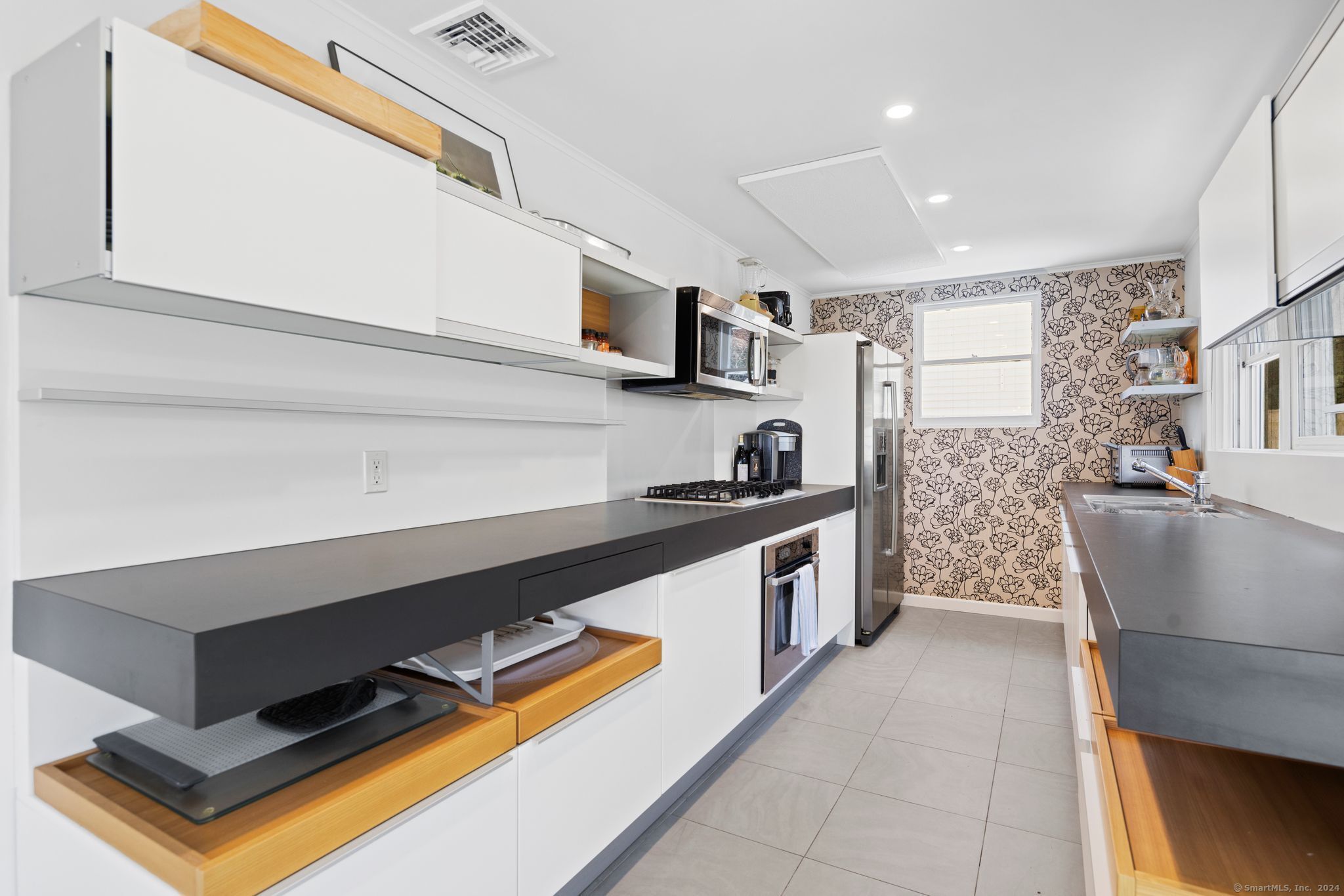 232 Hillspoint Road Westport, CT 06880 - Photo 13 of 39 a kitchen with stainless steel appliances granite countertop a sink and a stove