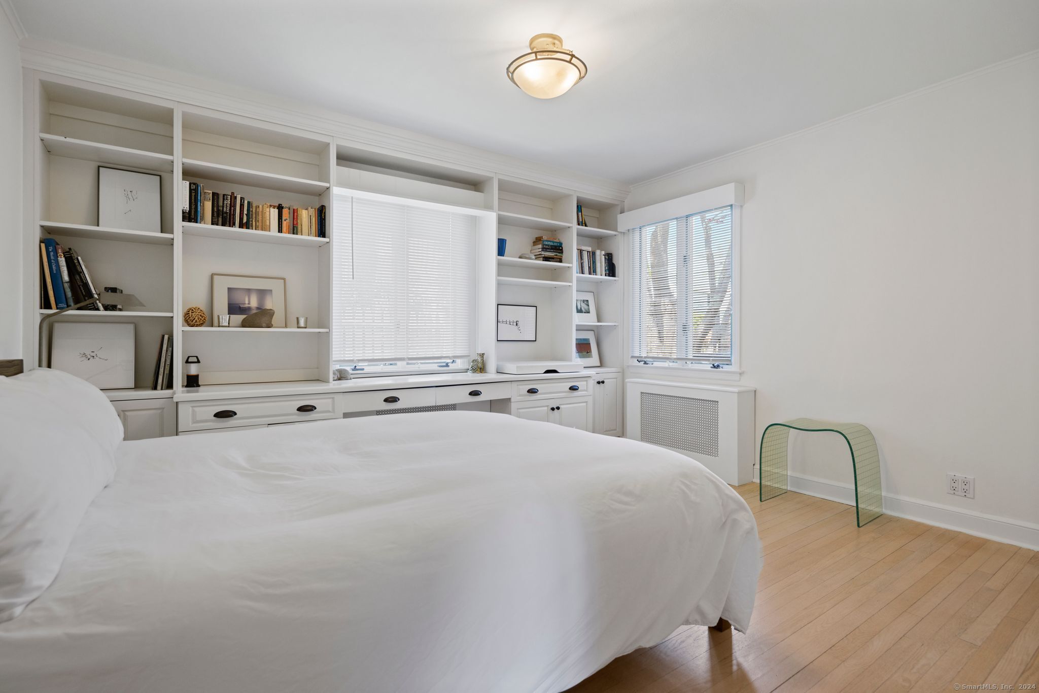 232 Hillspoint Road Westport, CT 06880 - Photo 15 of 39 a spacious bedroom with a bed a table and a large window