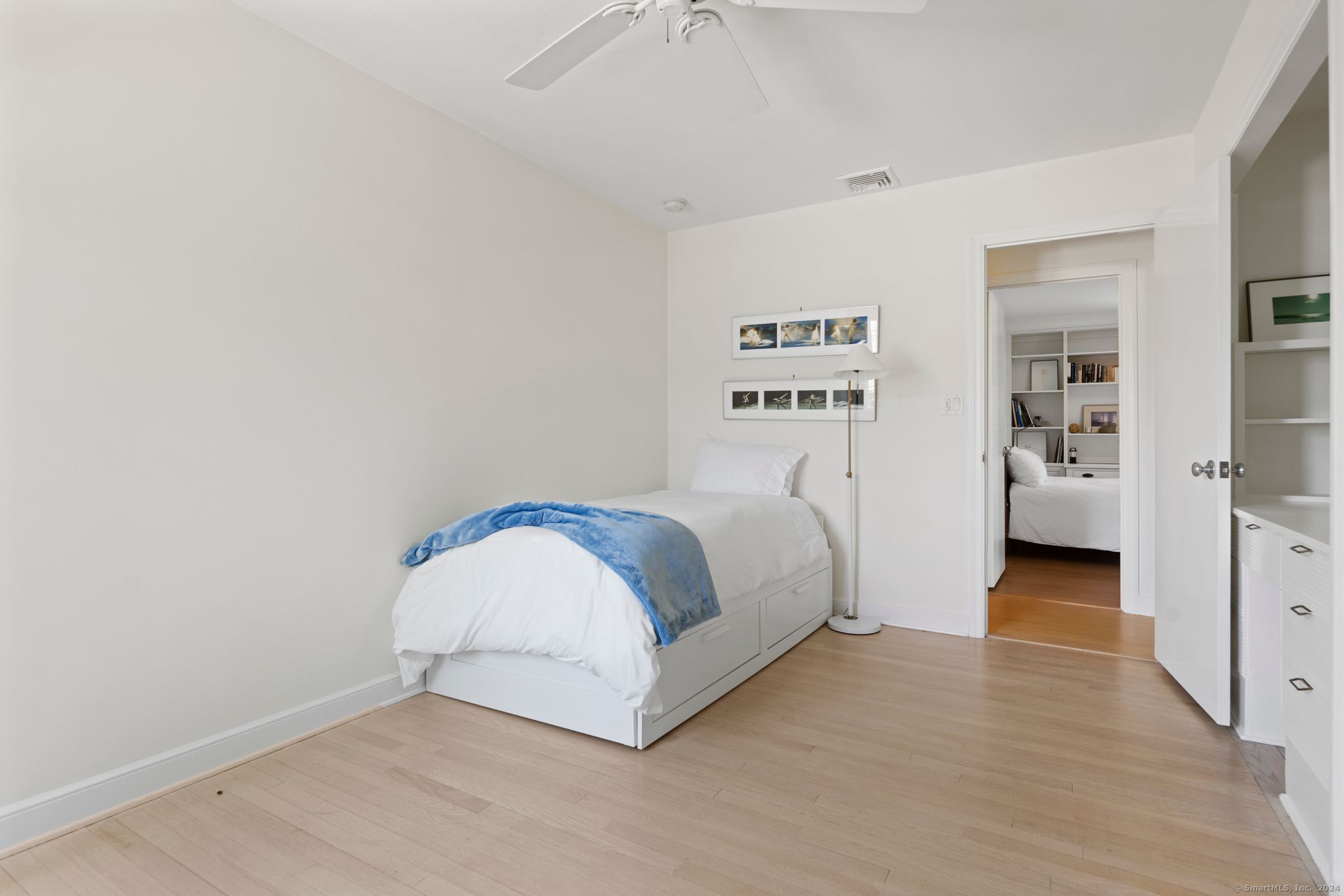 232 Hillspoint Road Westport, CT 06880 - Photo 17 of 39 a spacious bedroom with a bed and a walk in closet