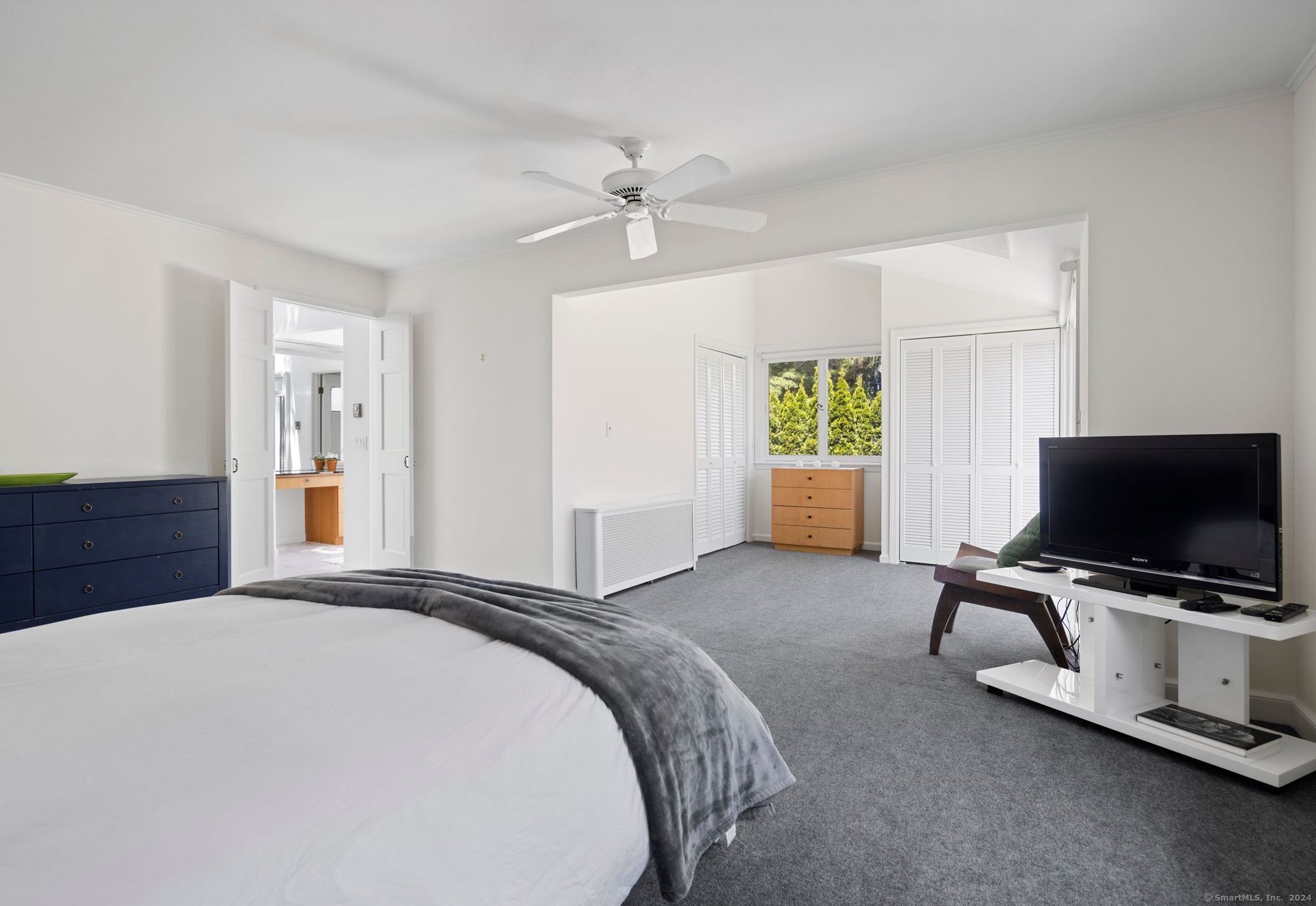 232 Hillspoint Road Westport, CT 06880 - Photo 30 of 39 a bedroom with a bed and a flat screen tv