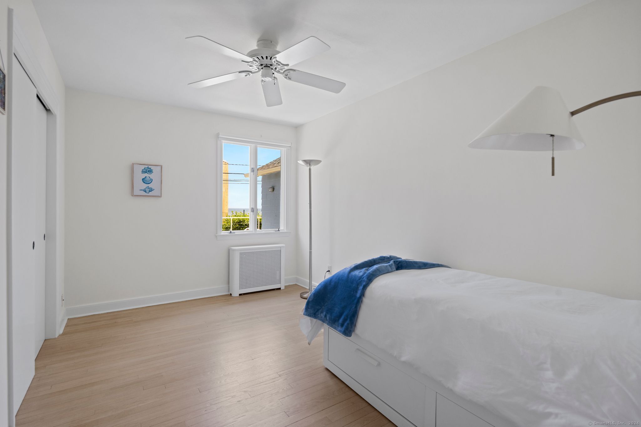 232 Hillspoint Road Westport, CT 06880 - Photo 33 of 39 a bedroom with a bed and a chandelier