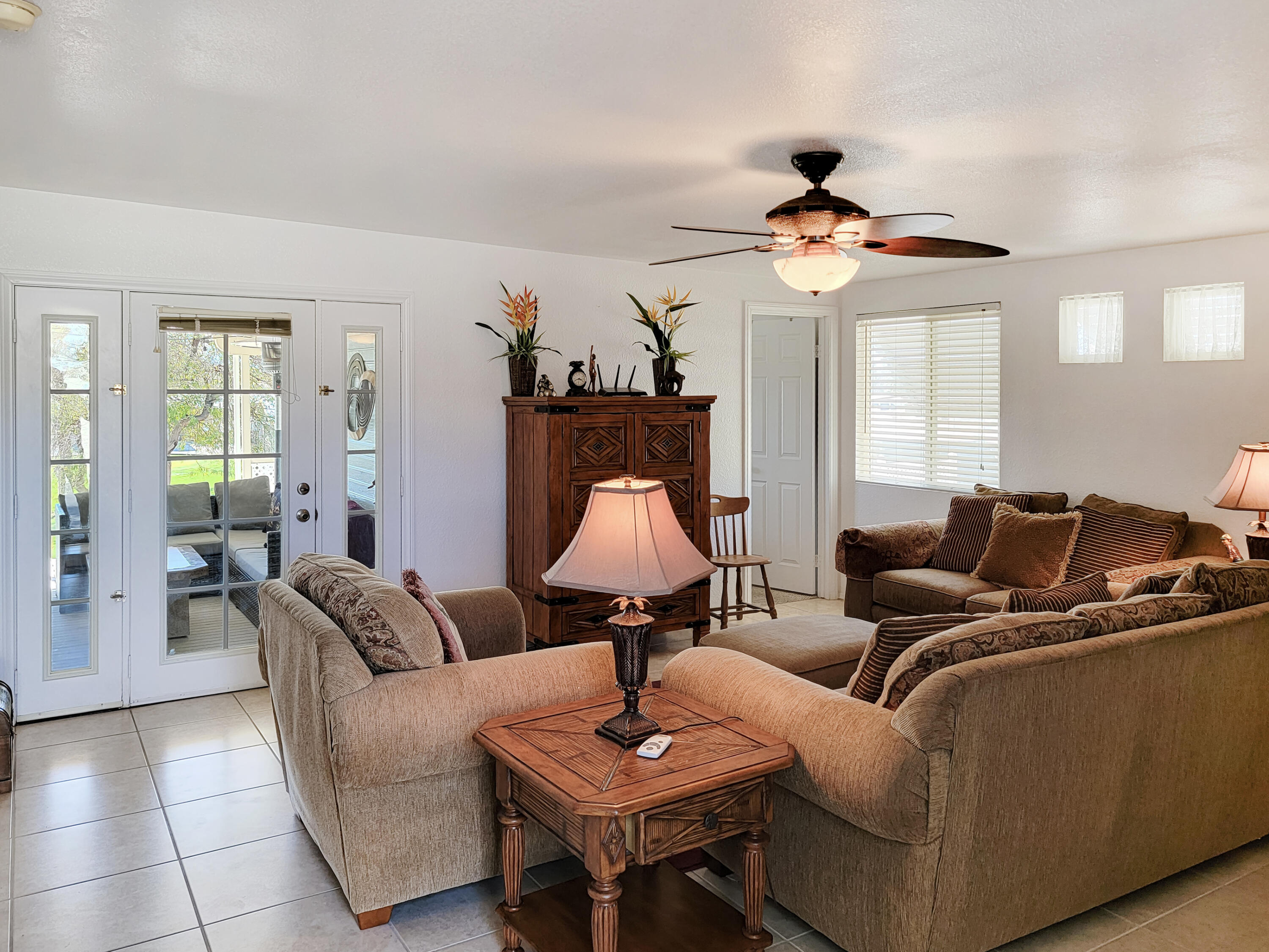 70200 Dillon Road, Unit 496 Desert Hot Springs, CA 92241 - Photo 8 of 43 a living room with furniture and a lamp