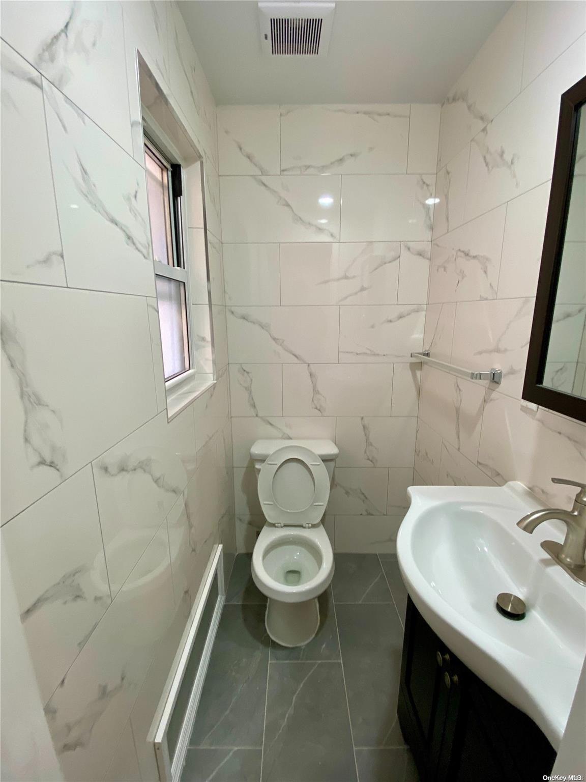 108-14 37th Avenue Queens, NY 11368 - Photo 16 of 22 a bathroom with a sink toilet and shower