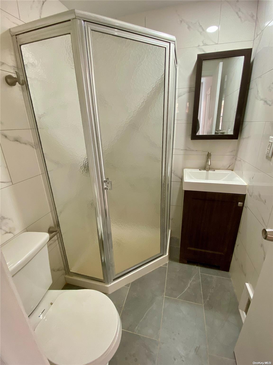 108-14 37th Avenue Queens, NY 11368 - Photo 18 of 22 a bathroom with a sink a toilet and shower