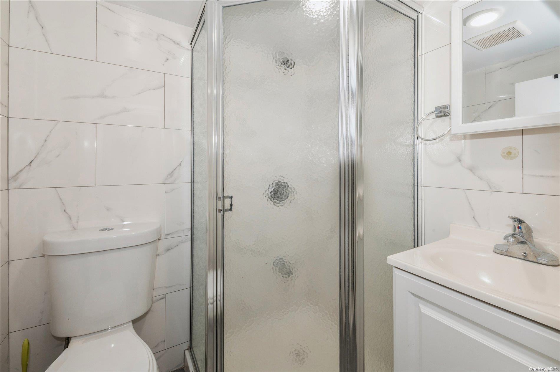 108-14 37th Avenue Queens, NY 11368 - Photo 20 of 22 a bathroom with a toilet and a shower