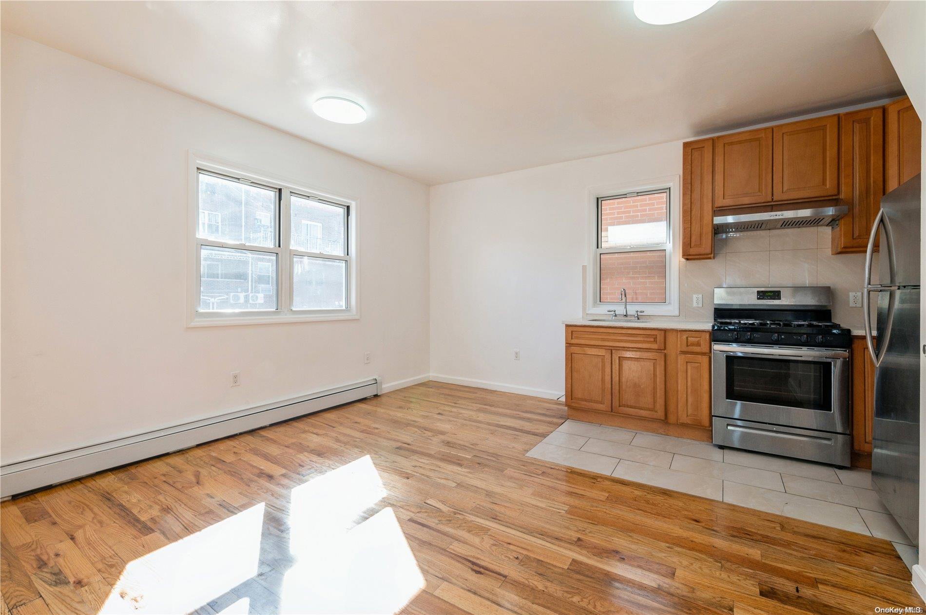 108-14 37th Avenue Queens, NY 11368 - Photo 2 of 22 a kitchen with a stove and a microwave