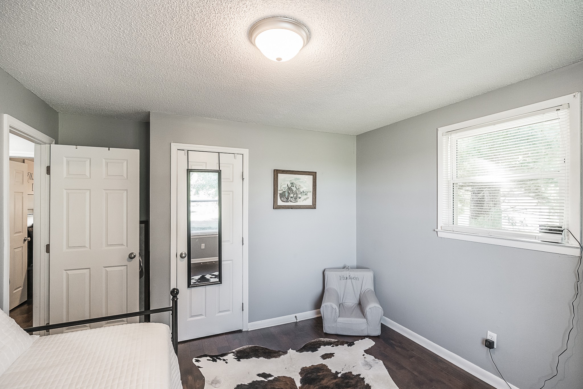 4451 Roy Cole Road Springfield, TN 37172 - Photo 23 of 43 a bedroom with a baby bed a couch and a window