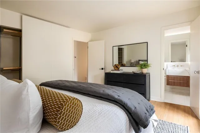 a bedroom with a bed and a mirror