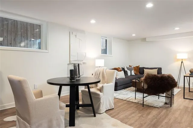a living room with furniture a window and a table