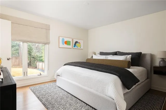 a bedroom with a bed and a large window