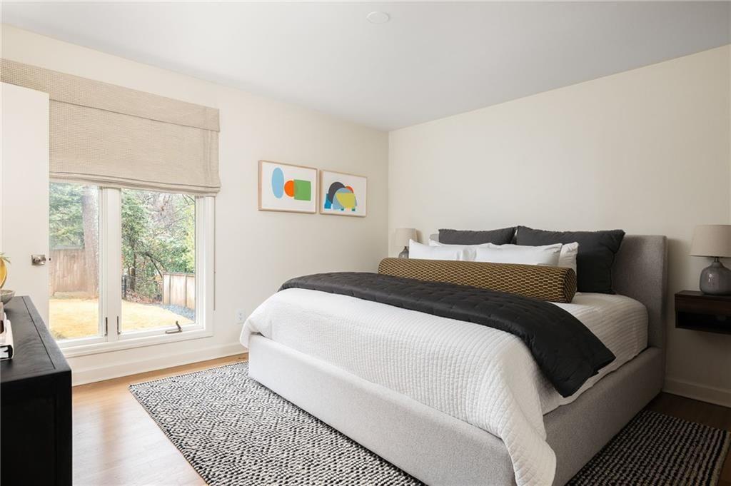 902 Cumberland Road Northeast Atlanta, GA 30306 - Photo 10 of 22 a bedroom with a bed and a large window