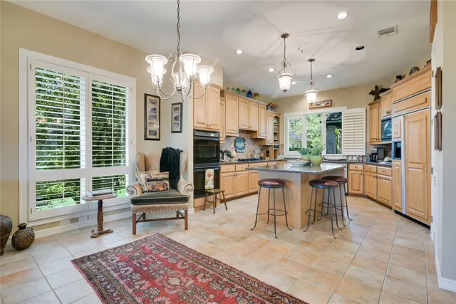 a large bathroom with a double vanity sink a mirror and a bathtub