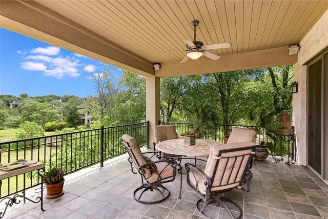 a view of a patio with a table chairs and a backyard