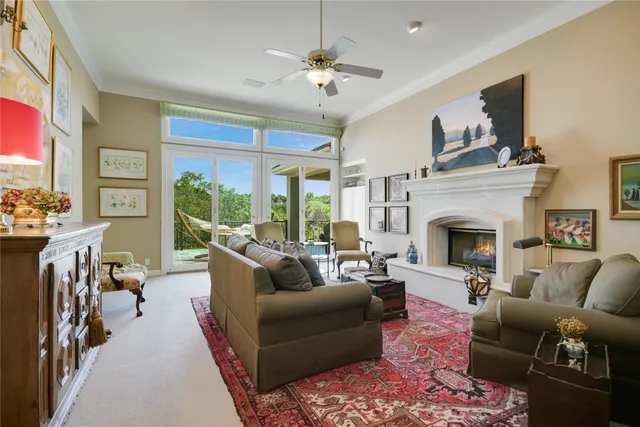 a living room with furniture fireplace and a large window