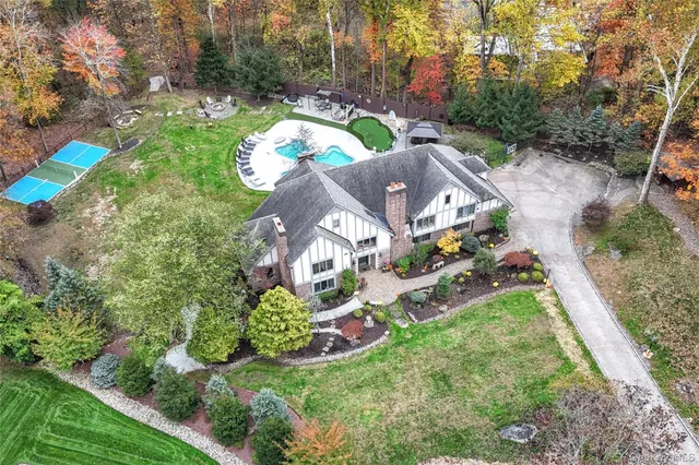 an aerial view of residential house with outdoor space and parking