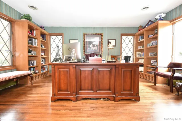a living room with couches chairs and large view with wooden floor