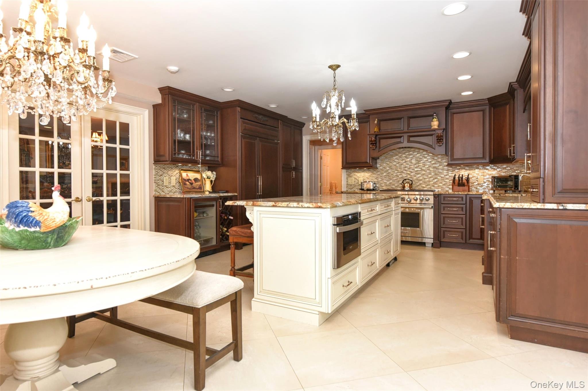 4 Abbey Road West Nyack, NY 10994 - Photo 14 of 50 a kitchen with stainless steel appliances kitchen island granite countertop a stove a sink a refrigerator dining table and chairs