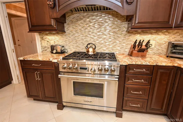 a stove top oven sitting inside of a kitchen