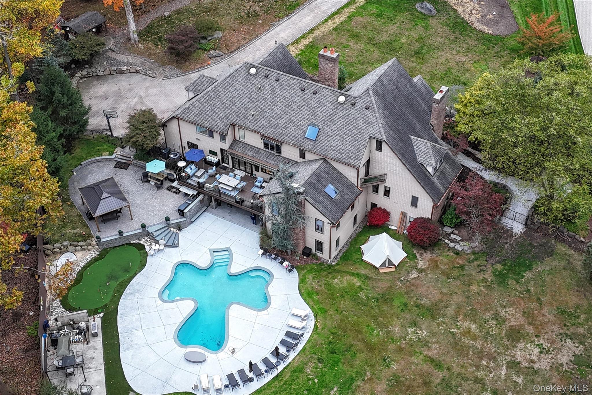 4 Abbey Road West Nyack, NY 10994 - Photo 2 of 50 an aerial view of a house with a swimming pool a yard and a garage