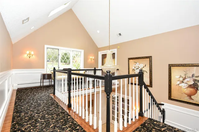 a view of hallway with furniture and a window