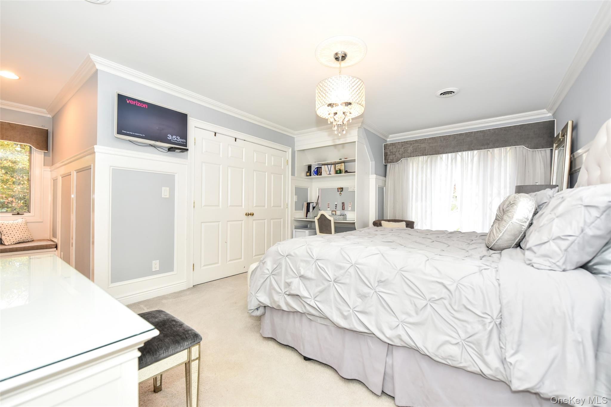 4 Abbey Road West Nyack, NY 10994 - Photo 27 of 50 a spacious bedroom with a bed and a chandelier