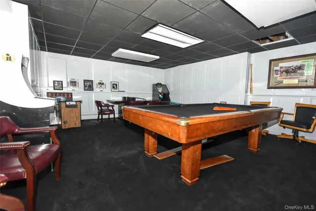 a room with furniture pool table and windows