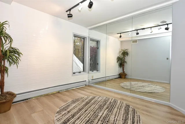 a view of a room with wooden floor and windows