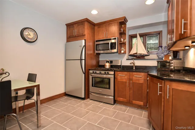 a kitchen with stainless steel appliances a stove a sink and a refrigerator
